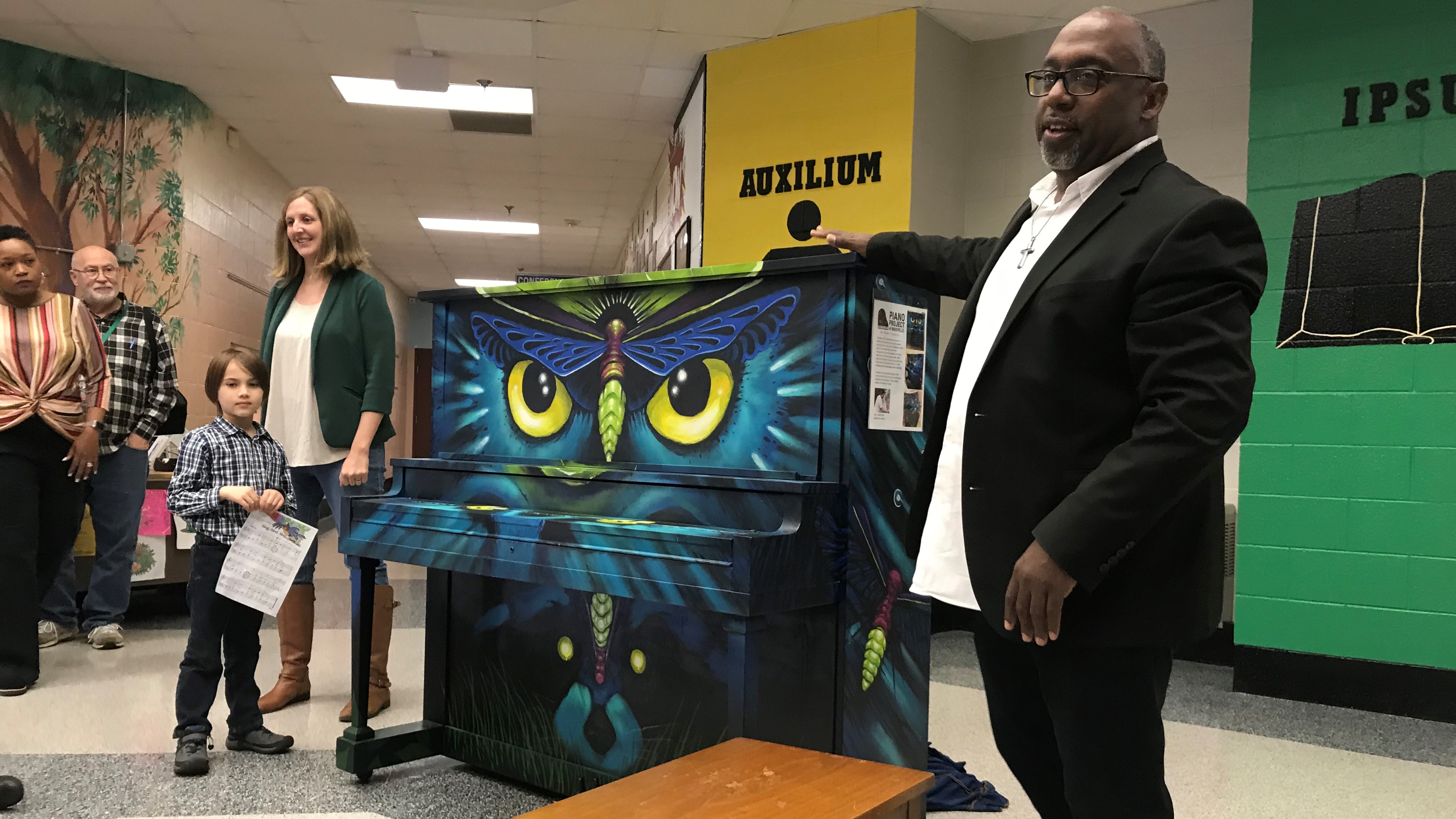 Brian Clay, founder of the Piano Project of Knoxville, tells students about a new piano that has been donated to Dogwood Elementary School. 